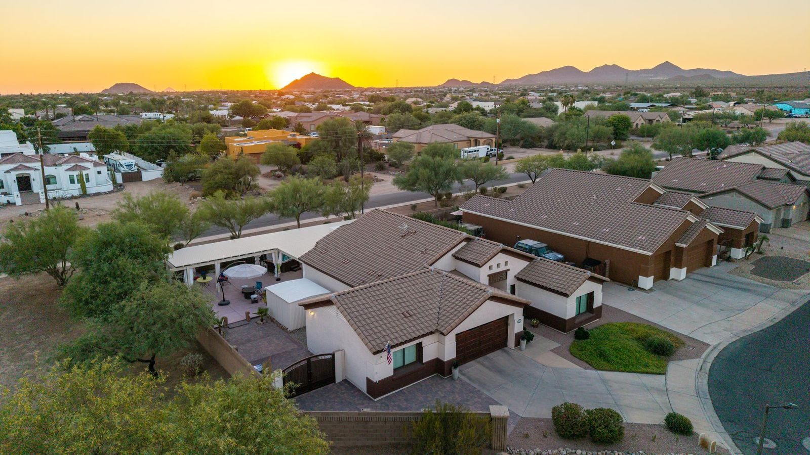 Drone view of rooftops with the sun on the horizon