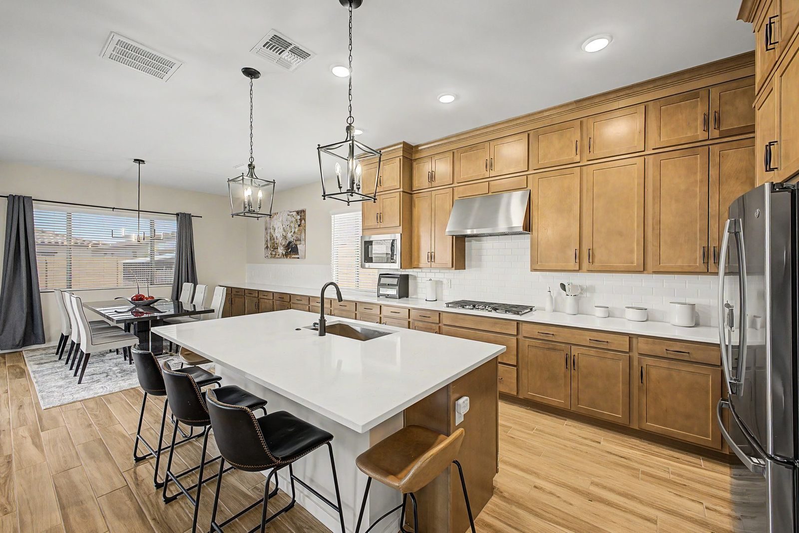 Kitchen with island, pendant lights and wood cabinets